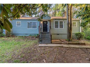 Charming single-story home featuring a black front door and a quaint, inviting exterior at 1753 Beechwood Sw Blvd, Atlanta, GA 30311