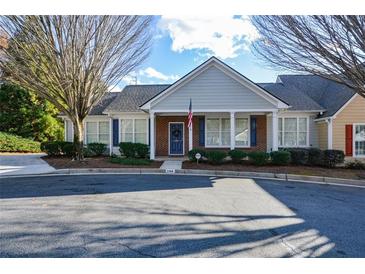 Charming single-story home with blue door, neat landscaping, and ample parking on a sunny day at 2368 Barrett Cottage # 17, Marietta, GA 30066