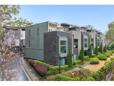 Modern townhome with sleek gray and brick facade, professional landscaping, and private drive at 728 Oakview Rd, Decatur, GA 30030