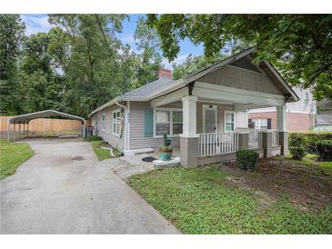Charming bungalow-style home featuring a covered carport and a quaint front porch at 972 Sims Nw Ave, Atlanta, GA 30318
