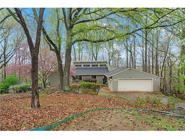 Inviting home featuring beautiful landscaping and a spacious two-car garage at 3696 Suwanee Creek Ct, Suwanee, GA 30024