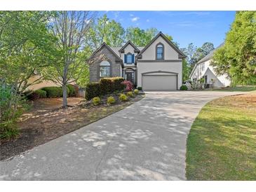 Charming two-story home featuring a long driveway and well-manicured landscaping at 1363 Brentwood Ln, Marietta, GA 30062