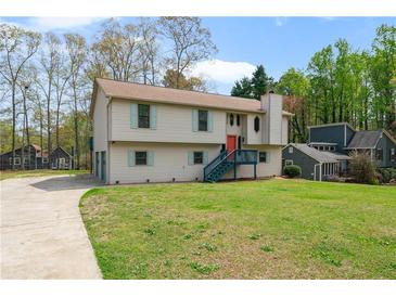 Inviting two-story home with a well-manicured lawn, attached garage, and charming curb appeal at 1612 Sky Crest Dr, Lithia Springs, GA 30122