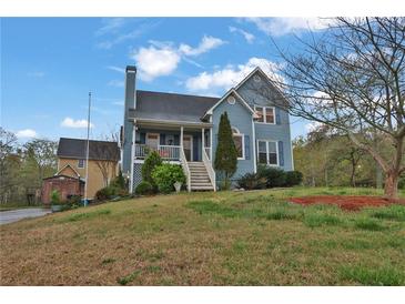 Charming two-story home features a covered porch and well-maintained landscaping at 524 Lambeth Dr, Hiram, GA 30141