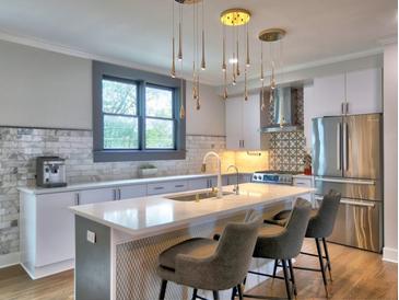 Modern kitchen featuring a center island with bar seating, stainless steel appliances, and stylish pendant lighting at 88 Peachtree Memorial Nw Dr # 88, Atlanta, GA 30309