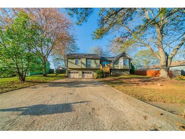Charming two-story home with a spacious driveway and attached two-car garage at 895 Tyrell Dr, Austell, GA 30106
