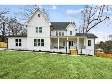 Stunning two-story home featuring a welcoming front porch and fresh green lawn at 1967 Nash Se Ave, Atlanta, GA 30316