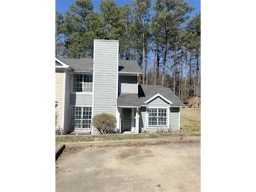Charming two-story home with a gray facade and a well-maintained front yard at 2575 Picardy N Cir # B, Atlanta, GA 30349