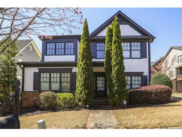 Charming two-story home with black trim, fresh landscaping, and inviting stone walkway at 1784 Hollingsworth Nw Blvd, Atlanta, GA 30318