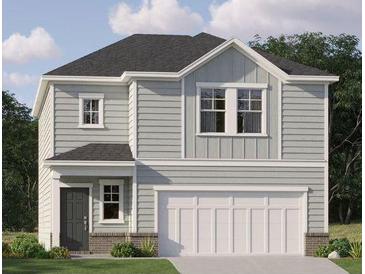 Charming two-story home with light gray siding, a white garage door and lush green landscaping at 321 Daybreak Dr, Acworth, GA 30102