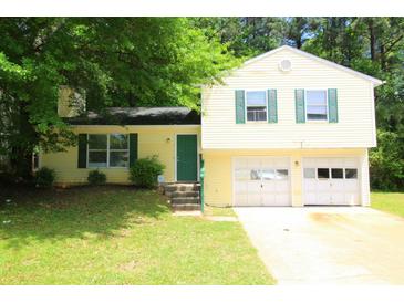 Charming two-story home with a two-car garage, complemented by green shutters at 2238 Scarbrough Dr, Stone Mountain, GA 30088