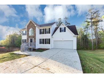 Charming two-story home boasts stone accents, a well-manicured lawn, and an attached two-car garage at 7746 New Castle Way, Jonesboro, GA 30236