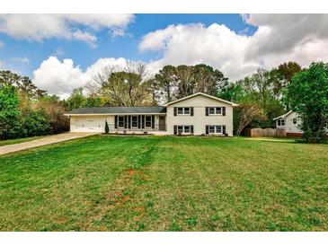 Charming two-story home featuring a manicured lawn, attached garage, and inviting curb appeal at 1741 Hasty Rd, Marietta, GA 30062