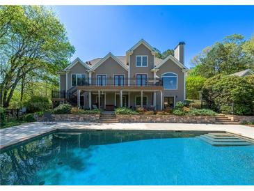 Stunning backyard pool and deck with a spacious two-story home in a private, lush setting at 20 Rivercreek Xing, Kingston, GA 30145
