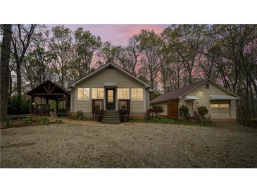Charming home features a symmetrical design, and a separate garage with a covered walkway at 5 Colonial Club Se Dr, Acworth, GA 30102