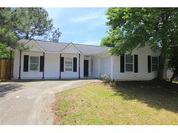 Charming single-story home with a black roof, black shutters, and a well-maintained front yard at 6269 Marbut Farms Rd, Lithonia, GA 30058
