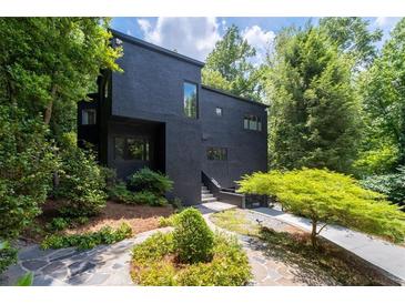 Stunning contemporary home with black exterior and lush landscaping at 4 W Wesley Nw Rdg, Atlanta, GA 30327