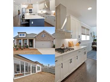 This spacious kitchen features modern appliances, white cabinetry, and a large center island with seating at 518 Newstead Way, Woodstock, GA 30188