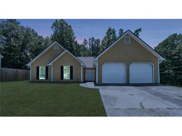 Charming single-story home featuring a two-car garage and well-maintained lawn at 6445 Marsham Dr, Atlanta, GA 30349