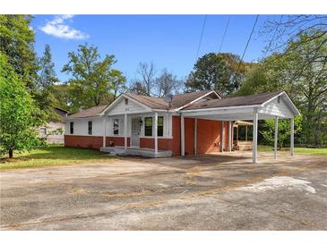 Charming single-story home with a brick foundation and covered parking at 126 Washington St, Mcdonough, GA 30253