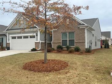 Charming single-Gathering home with a well-manicured front yard and attached two-car garage at 2660 Bateman Sw St, Powder Springs, GA 30127