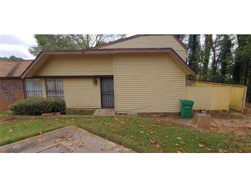 Cozy home with a front yard needing TLC and a fenced-in back yard at 3223 Strawberry Ln, Decatur, GA 30034
