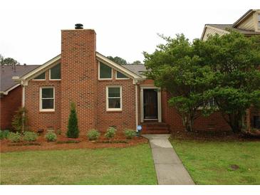 Charming brick home with well-manicured lawn and lush landscaping, featuring a brick chimney at 4631 Calumet Cir, Duluth, GA 30096