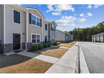 Charming townhome exteriors featuring neutral tones, brick accents, and well-maintained landscaping at 310 Ashigan St, Union City, GA 30291