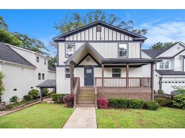 Charming two-story home with a welcoming front porch and well-manicured lawn at 1972 Cambridge Ave, Atlanta, GA 30337