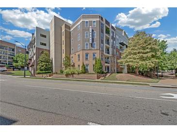 Contemporary condo building with neat landscaping, street view and a bright blue sky at 390 17Th Nw St # 4048, Atlanta, GA 30363