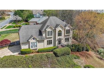 Stately two-story home with lush landscaping and mature trees providing shade and curb appeal at 4537 Ashmore Cir, Marietta, GA 30066