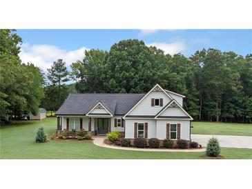 Charming one-story home featuring vertical siding and well-manicured landscaping at 340 Taylor Path, Dallas, GA 30157