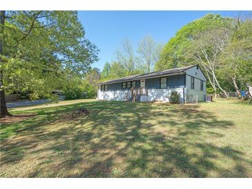 Charming single-story home featuring a large front yard with mature trees at 794 Casplan St, Atlanta, GA 30310