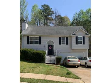 Charming two-story home with a cozy front yard and a driveway leading to an attached garage at 109 Millwheel Dr, Villa Rica, GA 30180