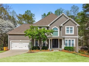 Charming two-story home with well-maintained lawn and attached two-car garage at 1165 Lea Dr, Roswell, GA 30076