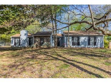 Charming single-story home with a stone facade and mature trees in a well-maintained yard at 181 Bernice Dr, Lawrenceville, GA 30045