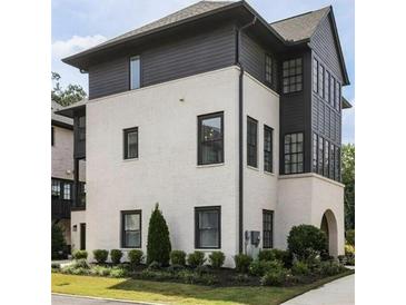 Charming exterior of a modern two-story home featuring white brick and black wood accents at 6626 Sterling Dr, Sandy Springs, GA 30328