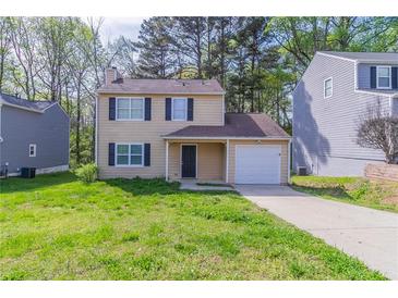 Charming two-story home with a one-car garage and a well-maintained front yard at 2030 Hilda Burns Pl, Lithonia, GA 30058