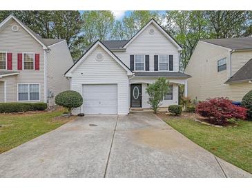 Charming two-story home with a manicured lawn, one-car garage, and inviting front porch at 240 Springbottom Ct, Lawrenceville, GA 30046