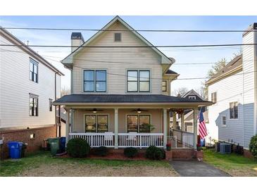 Charming two-story home featuring a covered front porch and a well-maintained yard at 93 Hammock Se Pl, Atlanta, GA 30312
