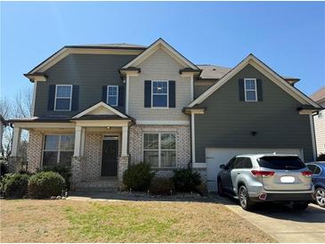 Charming two-story home with a brick and siding exterior and well-maintained landscaping at 404 After Glow Smt, Canton, GA 30114