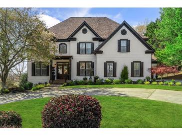 Charming two-story home with a manicured lawn, brick accents, and well-maintained landscaping at 1004 Windermere Xing, Cumming, GA 30041