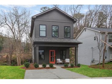 Charming two-story home with a modern facade, orange door, and a cozy front porch at 1005 Sims Nw Ave, Atlanta, GA 30318