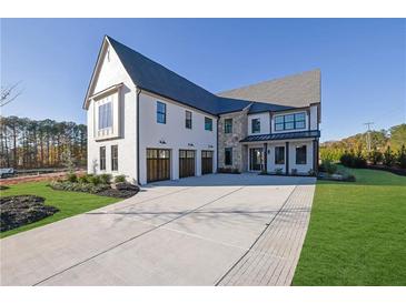 Stunning two-story home with a large driveway and three-car garage at 2875 Caney Parc Way, Cumming, GA 30041