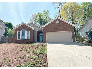 Charming single-story home with brick facade and two-car garage at 2910 Treehouse Ln, Lawrenceville, GA 30044