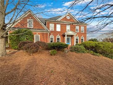 Attractive two-story brick home with manicured landscaping and a charming blue front door at 2123 Tigger Ne Trce, Marietta, GA 30066