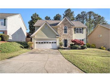 Charming two-story home features a stone accent facade, light siding, and attached garage at 3707 Mcguire Nw St, Kennesaw, GA 30144