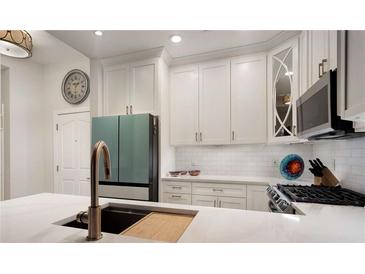 Bright kitchen boasts white cabinets, stainless steel appliances, and a sleek faucet at 850 Piedmont Ne Ave # 1206, Atlanta, GA 30308