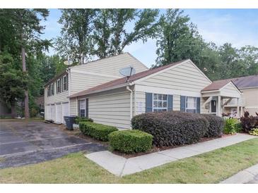 Charming townhouse with well-maintained landscaping and a neatly paved driveway at 1315 Old Coach Sw Rd, Marietta, GA 30008