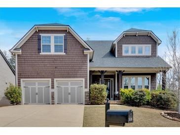 Charming two-story home with a well-manicured lawn and two-car garage at 359 Woodridge Pass, Canton, GA 30114